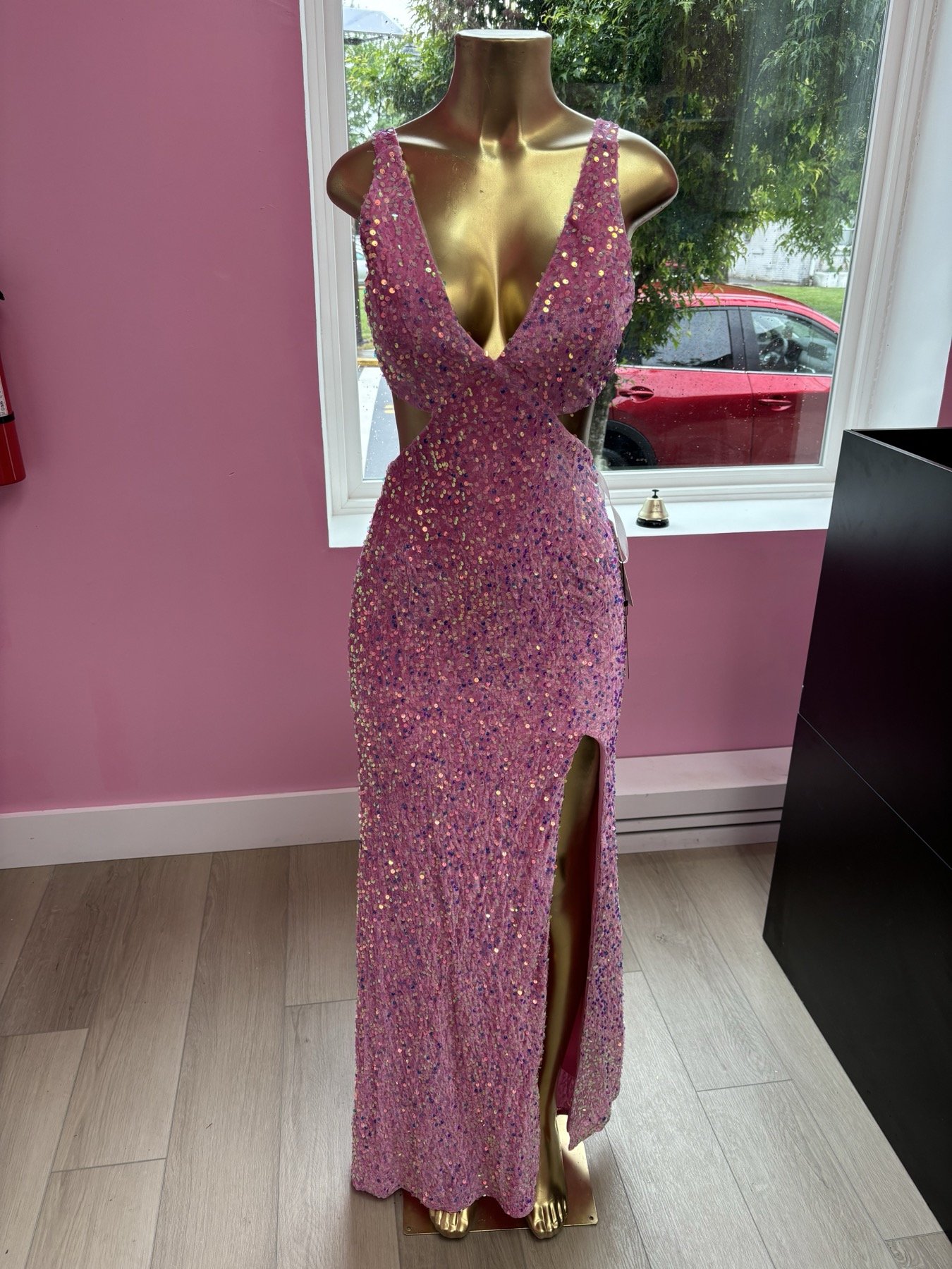Inside the Pink Is Life boutique with gown racks and chandelier