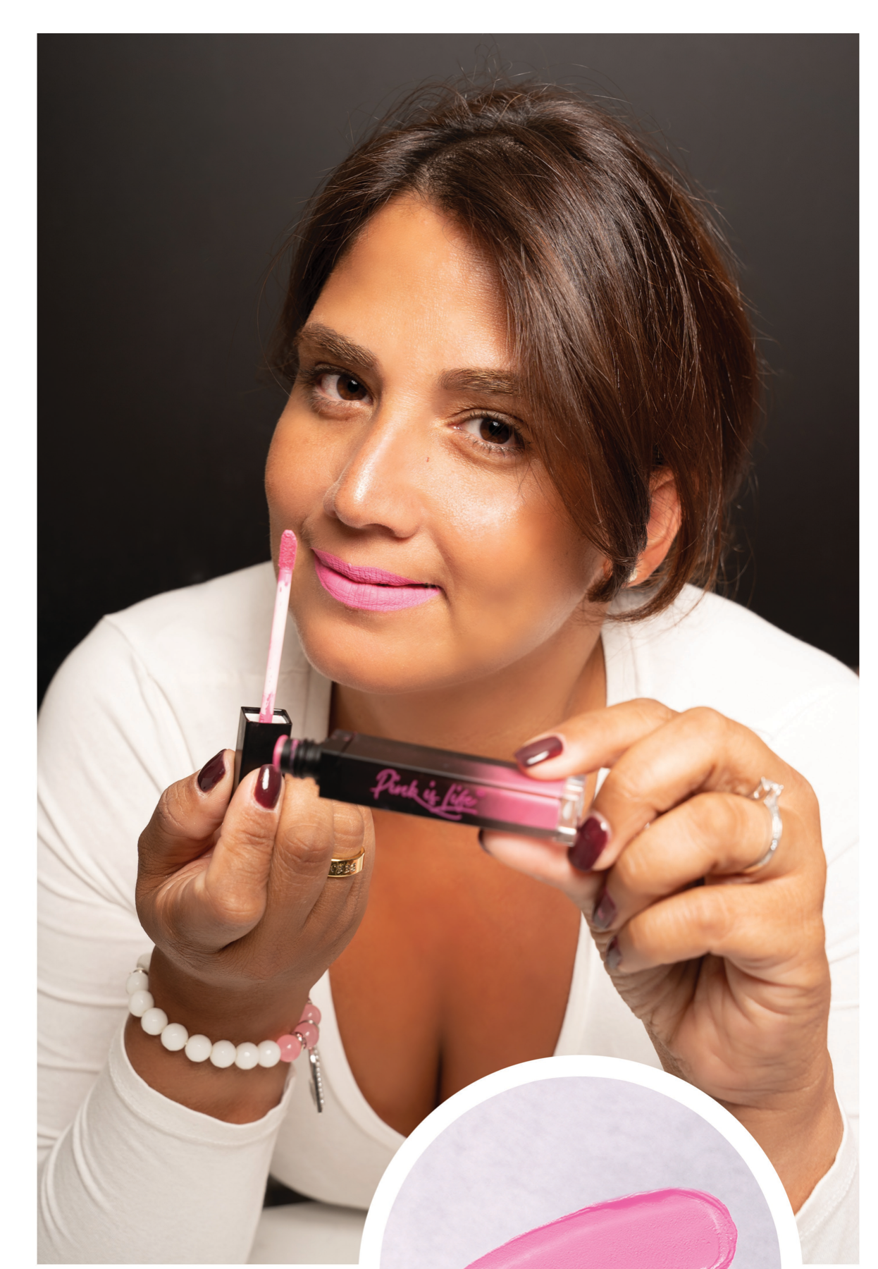 Bernice holding Guilty Pink liquid lipstick